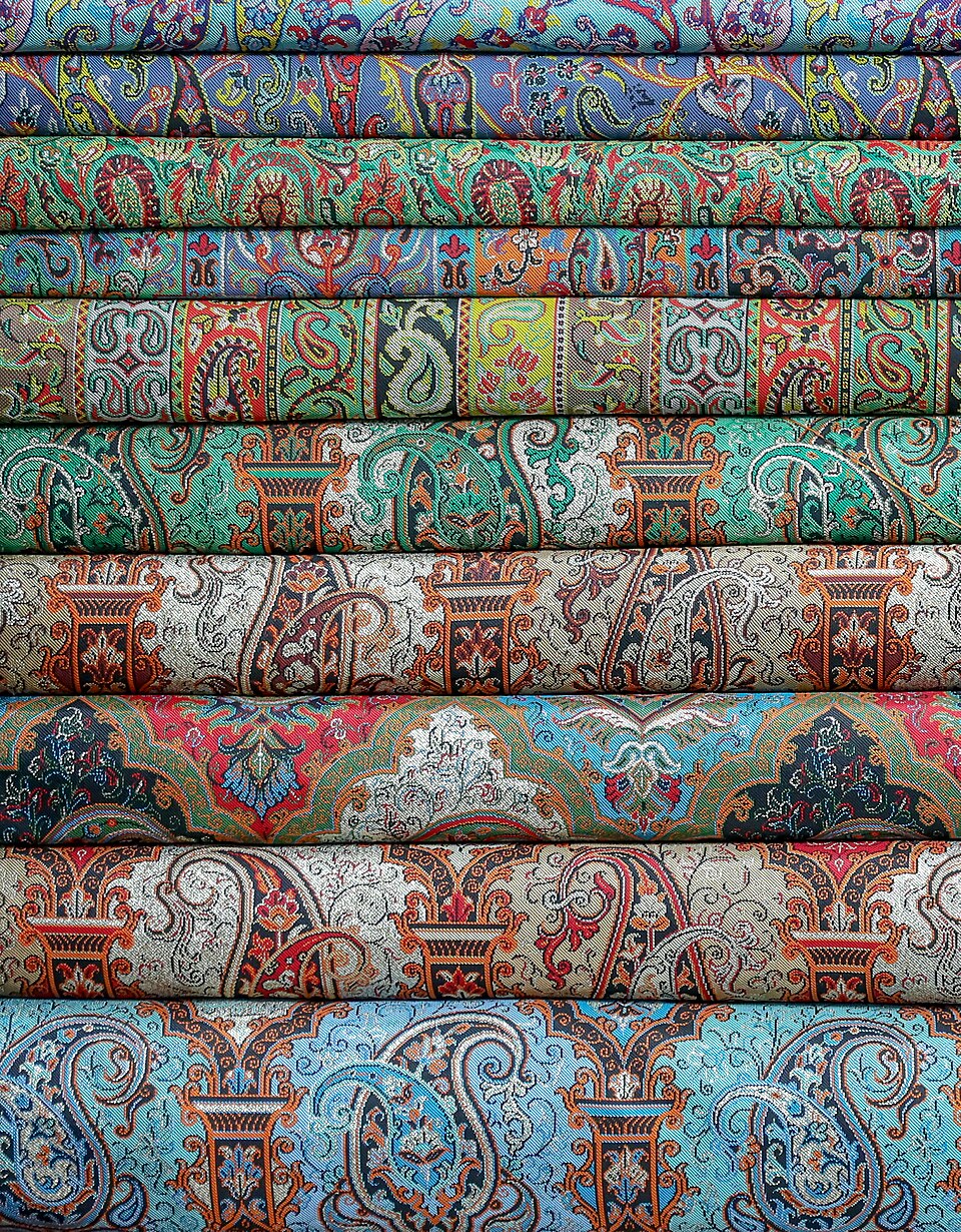 Close view of colorful handwoven Persian termeh fabric motifs in Yazd, Iran