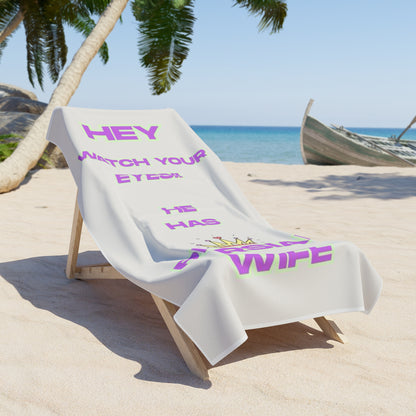 Beach towel with humorous text on a lounge chair at a tropical beach.